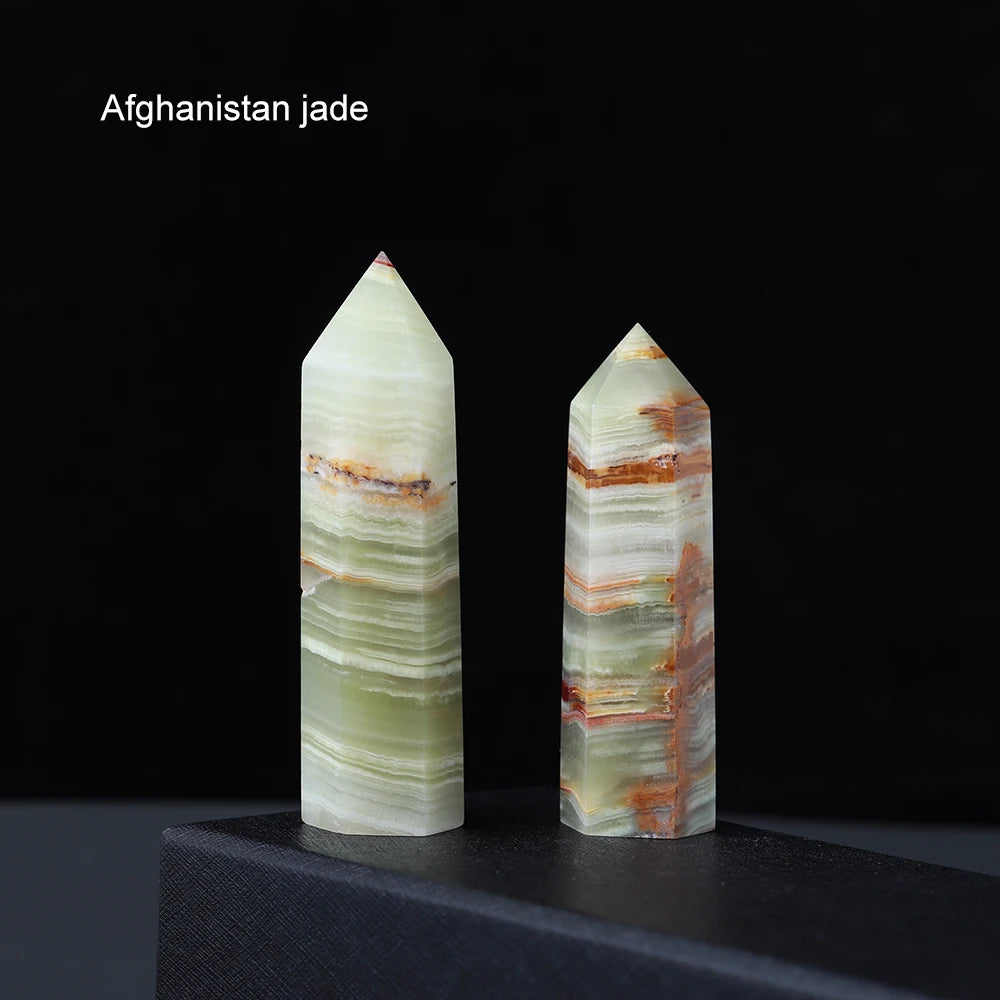 A pair of natural Afghanistan jade point prisms showing green and reddish-brown banding.
