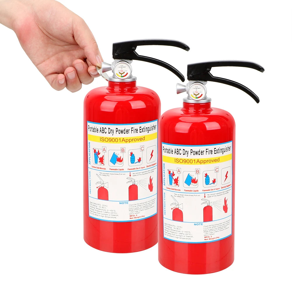 A hand holds two red dry powder fire extinguishers with yellow nozzles and safety seals.