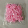 A clear plastic bag containing a pack of pink glow-in-the-dark star wall stickers.