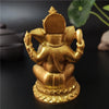 A handcrafted gold resin statue of Ganesha sitting on a lotus base.