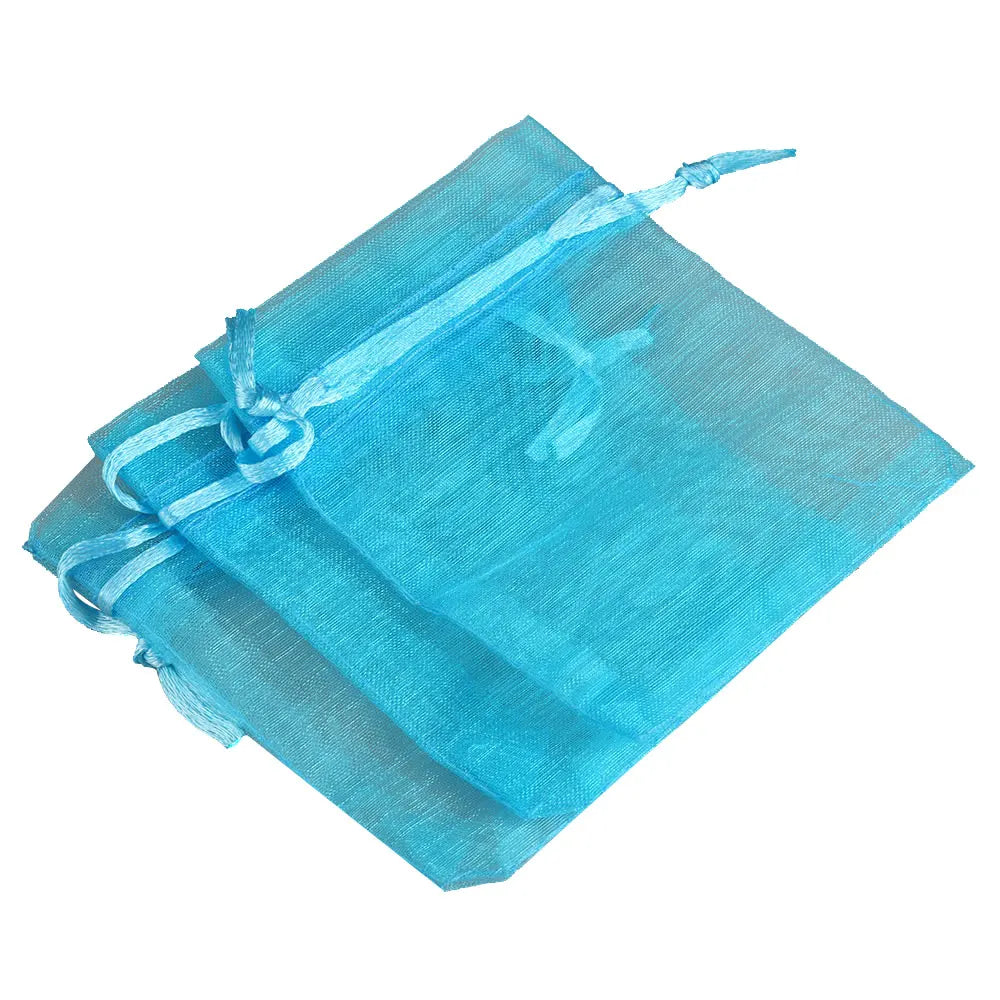 A stack of light blue organza drawstring gift pouches for jewelry, candy, or party favors.