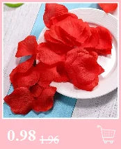 A pile of vibrant red silk rose petals on a white plate.