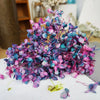 A cluster of handmade dried hydrangea flowers in shades of purple and blue