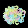 A collection of glow-in-the-dark star and moon wall stickers in pastel colors like yellow, pink, and blue.