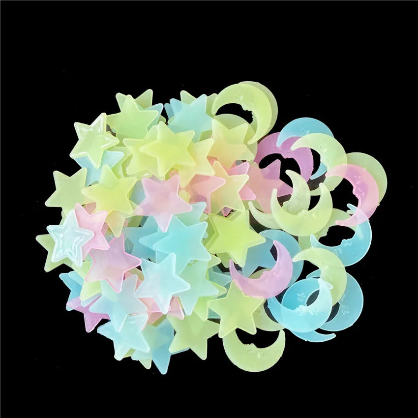 A collection of glow-in-the-dark star and moon wall stickers in pastel colors like yellow, pink, and blue.