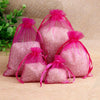 Pink glittery granular material packaged in sheer pink organza drawstring gift pouches