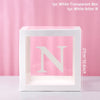 A white transparent box with a large white letter N inside, displayed against a pink background.