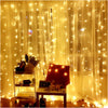 Outdoor LED string lights draped behind sheer yellow curtains with decorative elements.