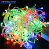 A tangled bundle of multicolor LED string lights with various colored bulbs and wires.