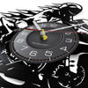 A black motorcycle rider vinyl record wall clock with a silver dial and a gold-colored hand.