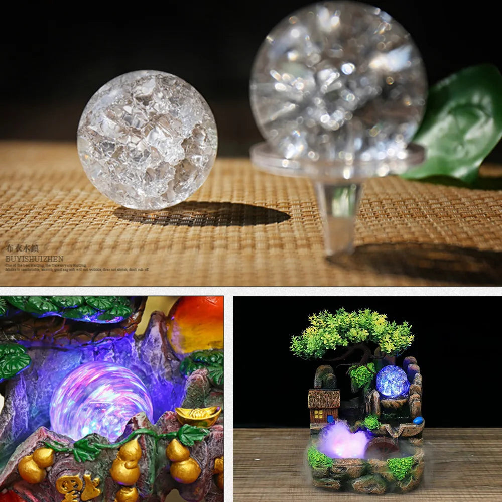 A crystal ball water feature ornament with a clear glass sphere and mossy natural setting.