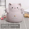 A cute, light purple cartoon cat piggy bank with smiling features sitting on a gray surface.