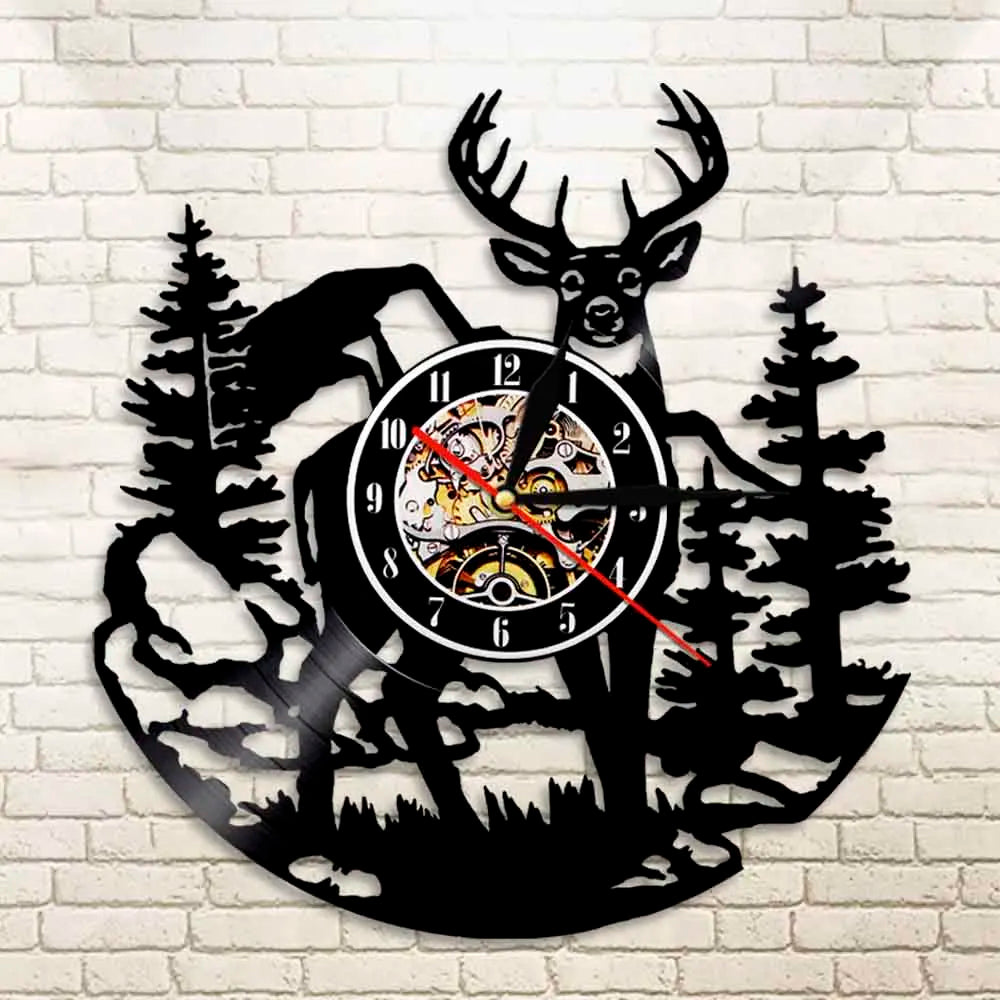 A black silhouette wall clock featuring a deer head and pine trees in a woodland theme.