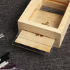 A vintage wooden photo frame set with a clear cover displaying a small aged card.