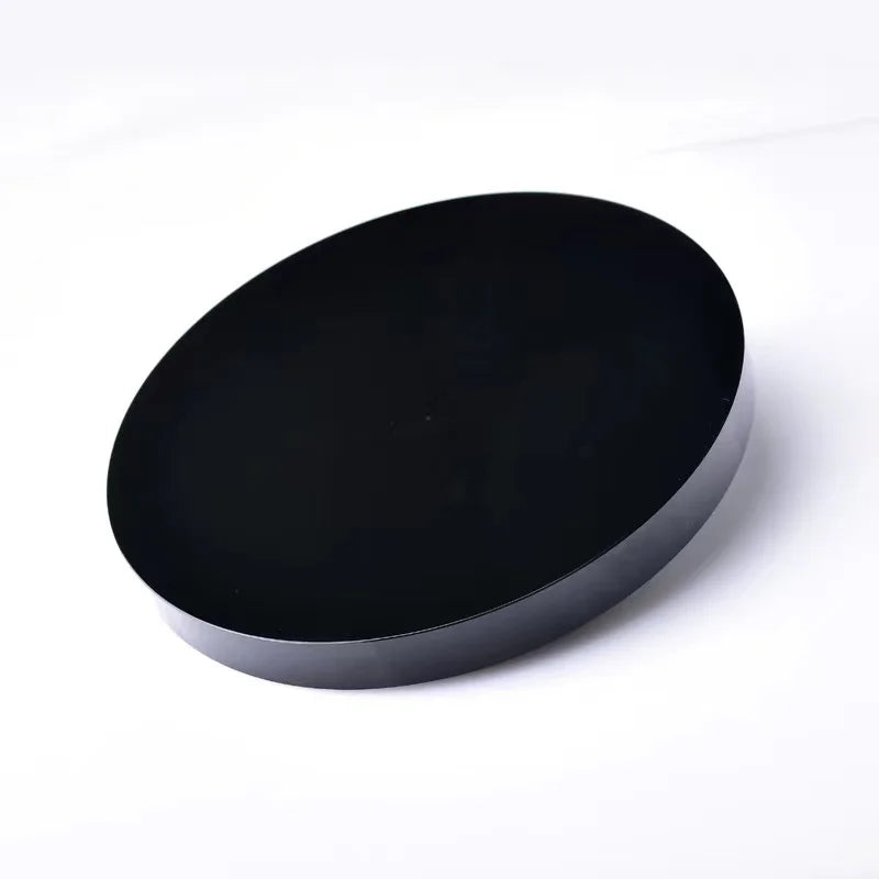 A round, matte black obsidian mirror used for psychic protection and divination.