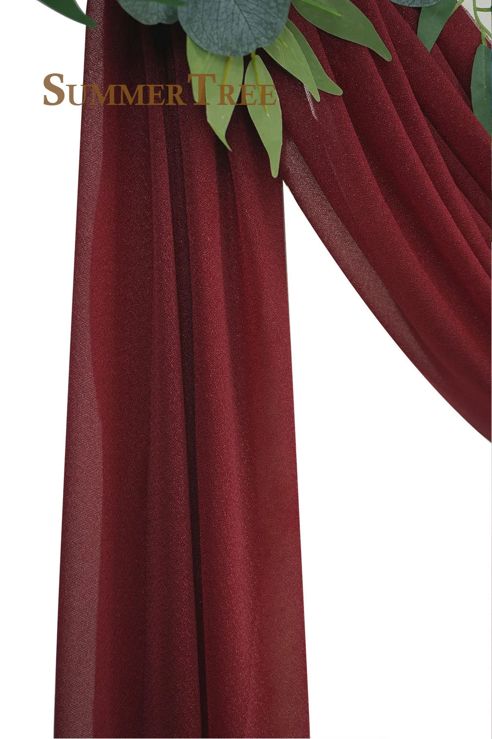 A close-up of a deep burgundy chiffon fabric used for an elegant wedding arch drape.