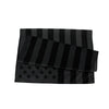 A stack of black and gray American flag banners made of durable polyester for outdoor display.