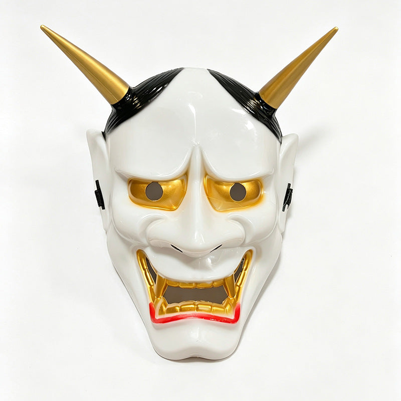 A white Japanese Hannya demon mask with golden eyes and horns, featuring a menacing expression.