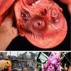 A close-up of a realistic, bloody prop of a severed head used for Halloween decor.