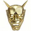 A full face Japanese Hannya demon mask with horns and fierce facial features, colored gold.