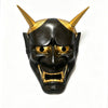 A full face Japanese Hannya demon mask with golden horns and dark skin, displayed against a white background.