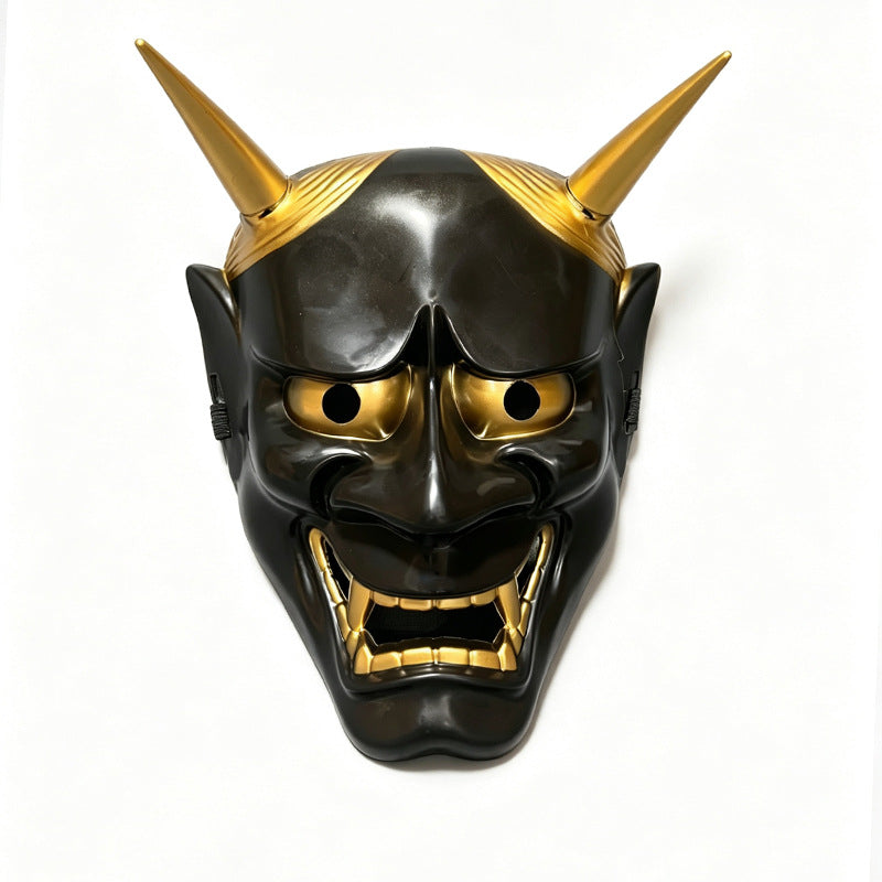 A full face Japanese Hannya demon mask with golden horns and dark skin, displayed against a white background.
