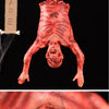 A realistic, bloody hanging corpse prop used for Halloween or haunted house decoration.