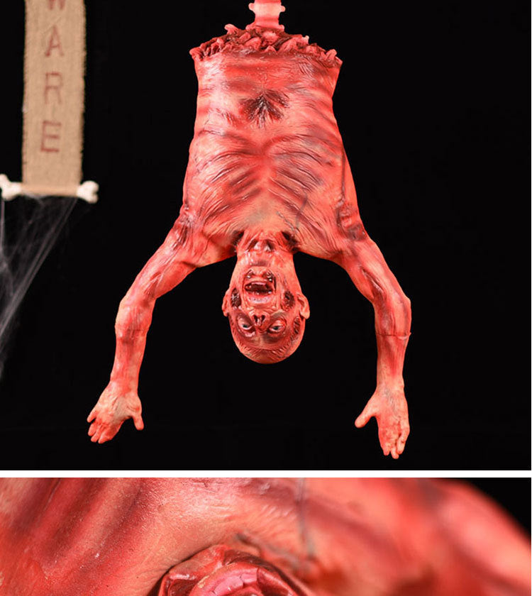 A realistic, bloody hanging corpse prop used for Halloween or haunted house decoration.