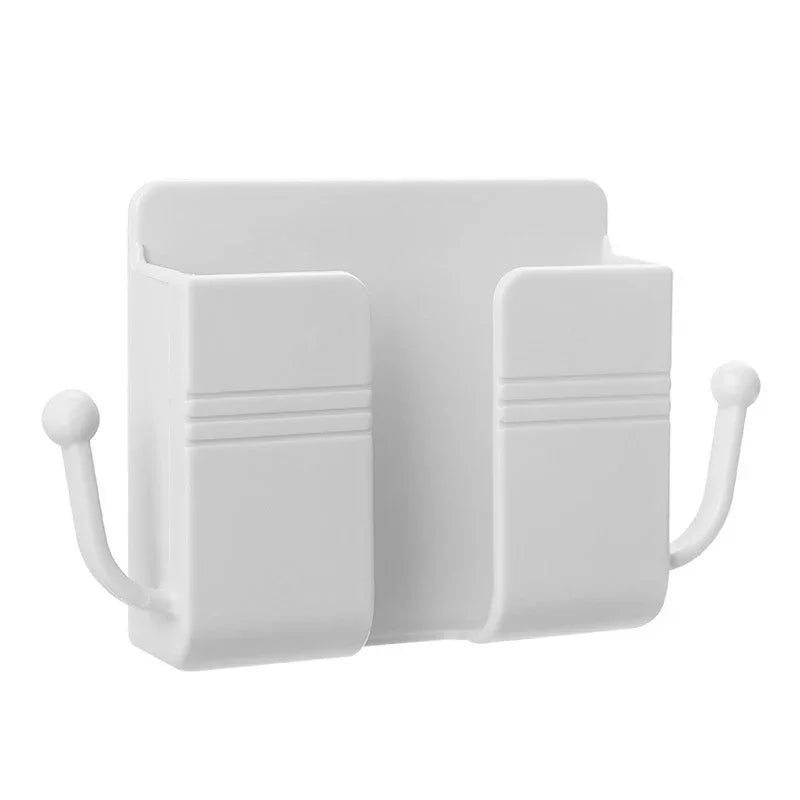 A white wall-mounted organizer with slots for a phone holder and charging dock.
