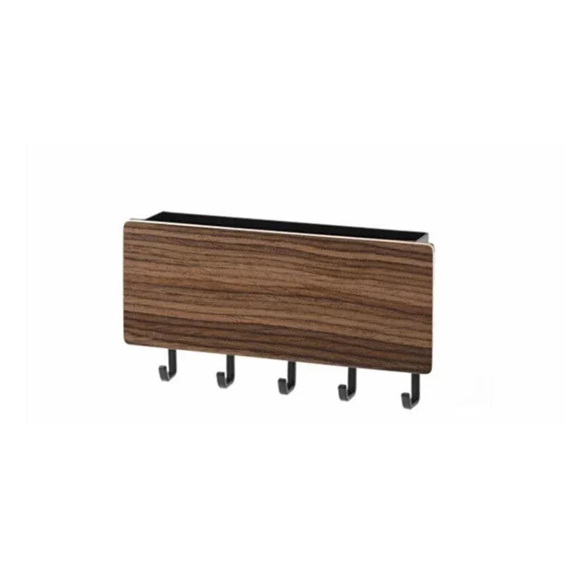 A brown bamboo wall-mounted key rack with six hooks.