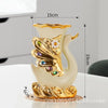 A pair of elegant ceramic swan vases featuring gold and cream colors for modern home decor.