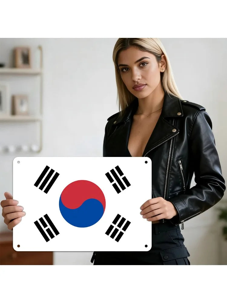 A woman holds a metal wall plaque featuring the South Korean Taegeukgi flag design.
