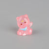 A pink resin keychain shaped like a cute, sleeping cat with a blue collar and yellow accents.