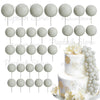 A set of white and light gray foam cake toppers on sticks for decoration.