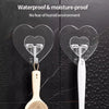 Transparent self-adhesive hooks with heart shapes attached to a wooden spoon and white handle