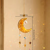 A hanging crystal dreamcatcher sun catcher featuring a golden crescent moon and dangling prism-cut crystals.