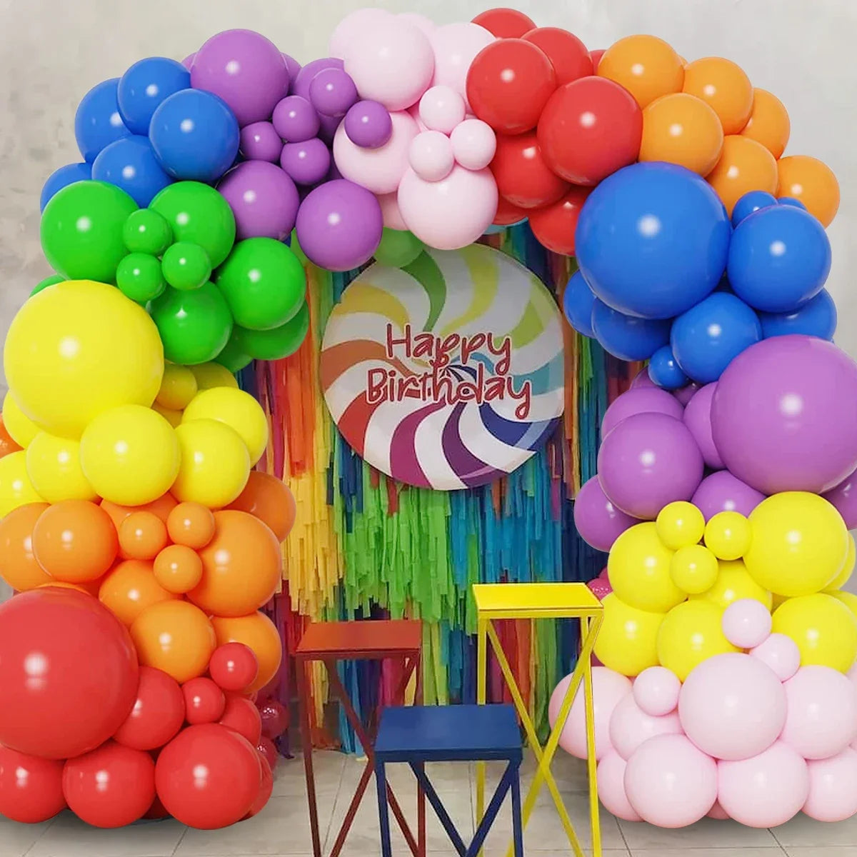 A colorful balloon garland arch kit featuring various shades of purple, pink, orange, yellow, and blue balloons for party dec