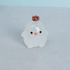 A small, translucent white resin ornament shaped like a chicken with a copper-colored comb and black eyes.