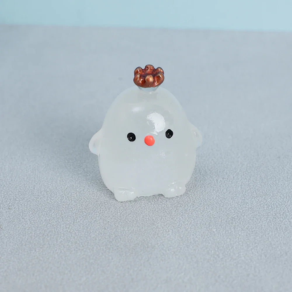 A small, translucent white resin ornament shaped like a chicken with a copper-colored comb and black eyes.