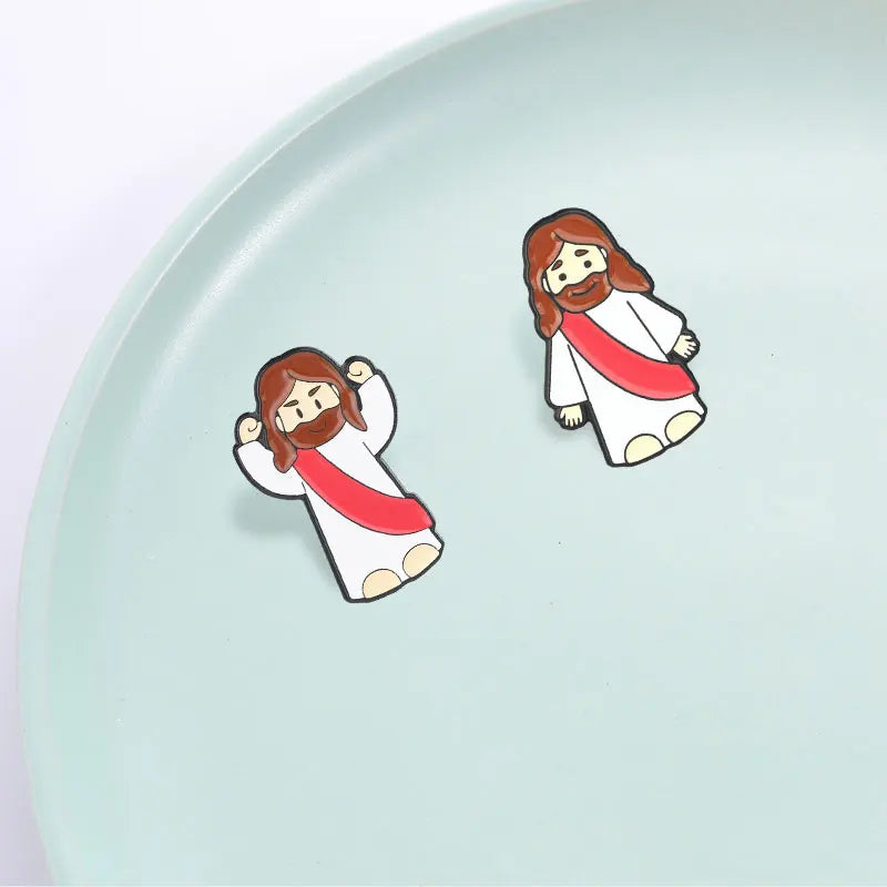 A small enamel lapel pin depicting Jesus with a beard and long hair, wearing a white garment and a red sash.