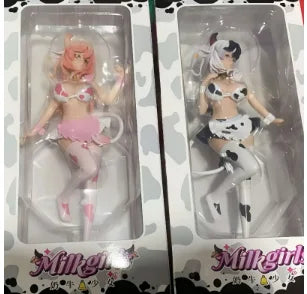 A set of two adorable cow-girl miniature figures in packaging.