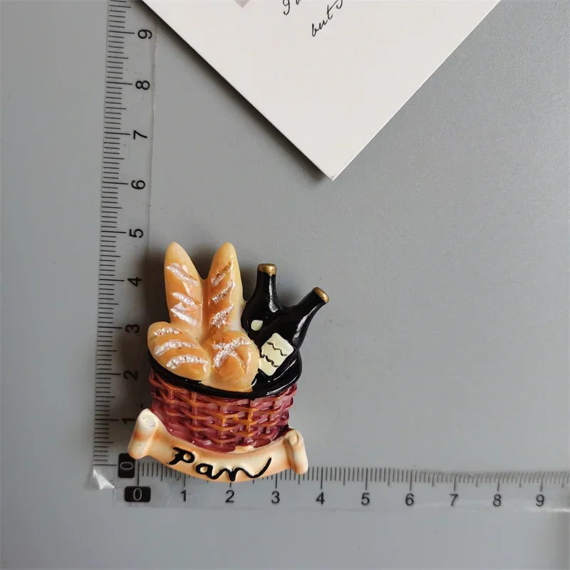 A set of playful food-shaped fridge magnets featuring a loaf of bread and a basket.