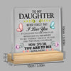 A clear acrylic desk sign with engraved text 'To my daughter I love you' and a message about seeing yourself through her eyes