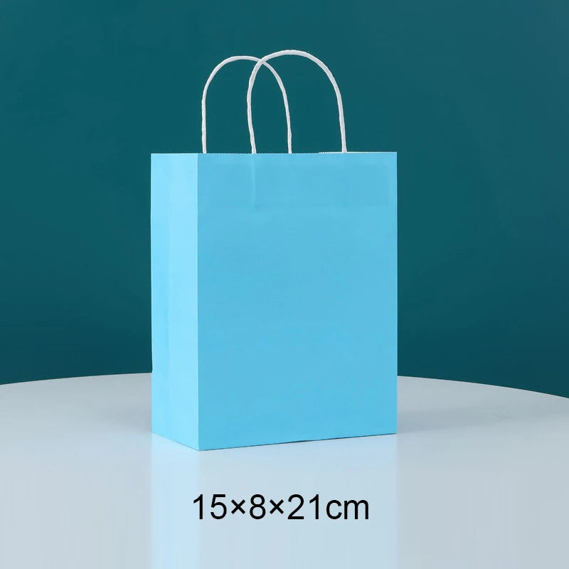 A light blue paper gift bag with white handles, shown against a dark teal background.