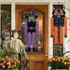 A set of Halloween hanging ornaments featuring ghosts, pumpkins, and skeletons displayed in a wooden frame.