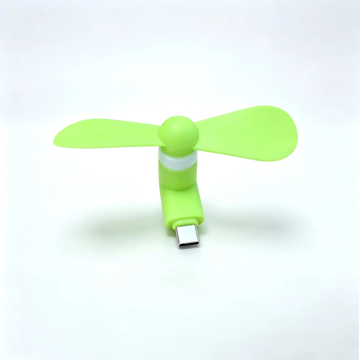 A bright lime green portable USB-C mini fan with soft blades and a silver connector.