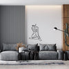 A modern living room featuring a gray sofa and a large black line art drawing of a figure on a white wall.