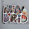 A collection of wooden destination fridge magnets shaped like the letters M A D, featuring colorful cityscapes and landmarks.