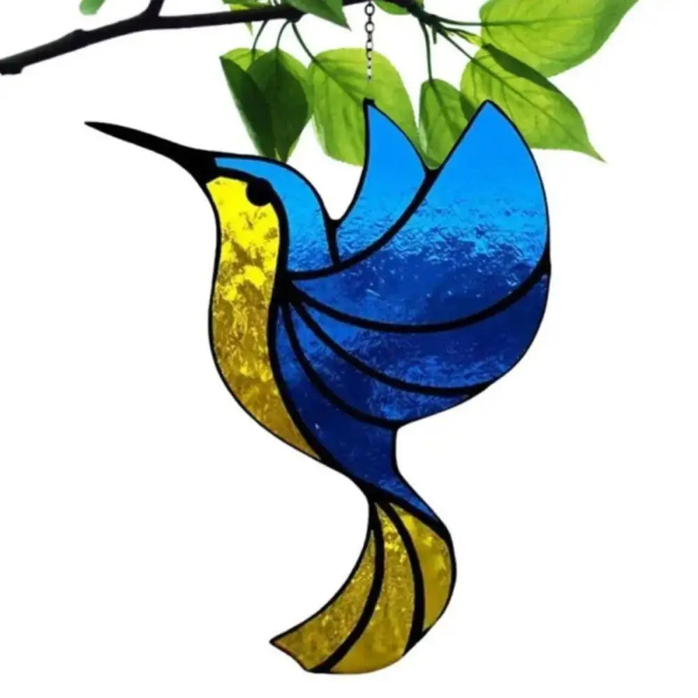 A colorful acrylic hummingbird suncatcher ornament with blue and yellow wings hanging from a green leaf.