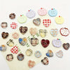 A collection of eight heart-shaped fridge magnets featuring various checkered and patterned designs in pink, green, yellow, a
